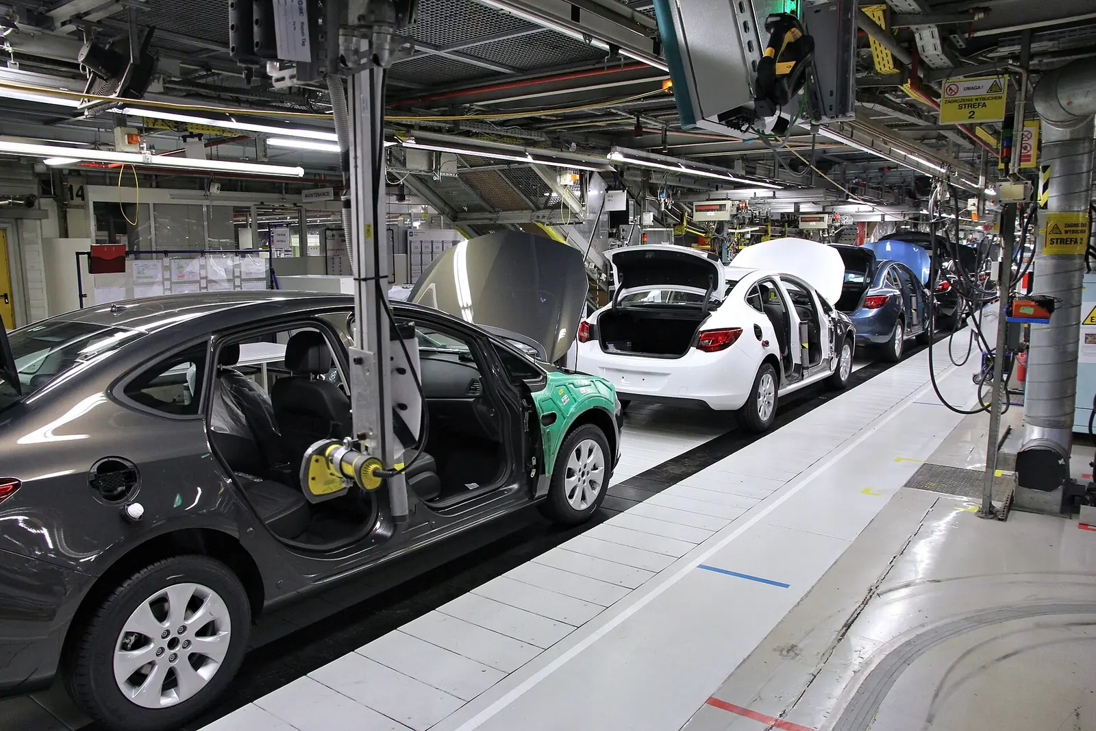 Cars moving along an assembly line