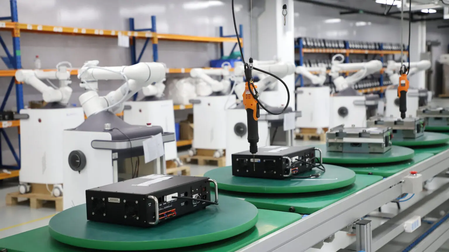 Robot arms over an electronics assembly line
