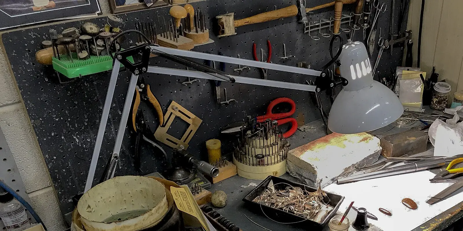 A silversmith's bench with tools and stones
